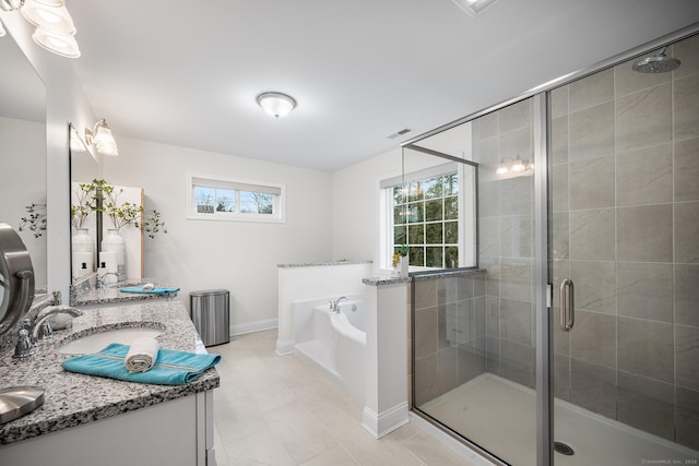 full bathroom with visible vents, a garden tub, double vanity, a stall shower, and a sink