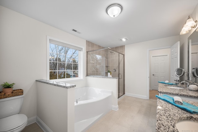 full bath with toilet, a sink, a shower stall, double vanity, and a bath