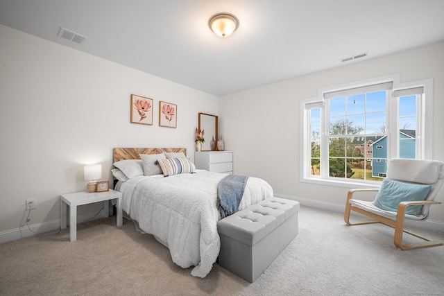 bedroom with baseboards, visible vents, and carpet floors