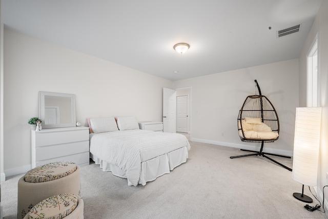 bedroom featuring visible vents, baseboards, and light colored carpet