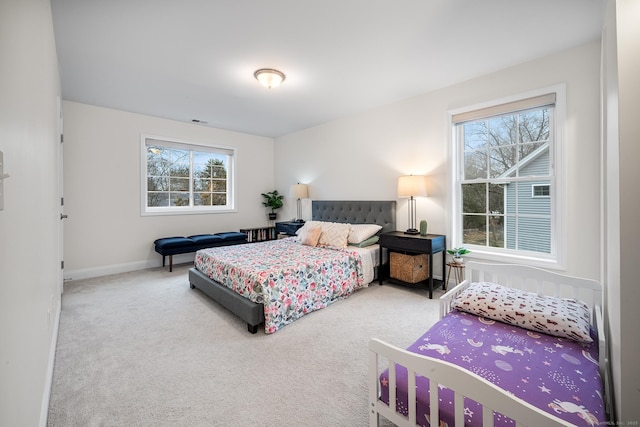 carpeted bedroom featuring visible vents and baseboards