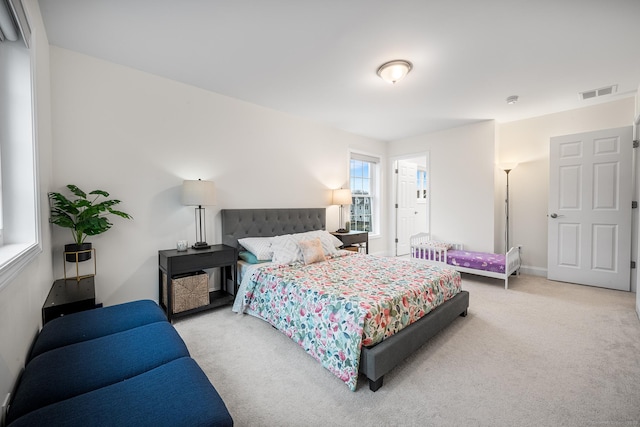 carpeted bedroom featuring visible vents and baseboards