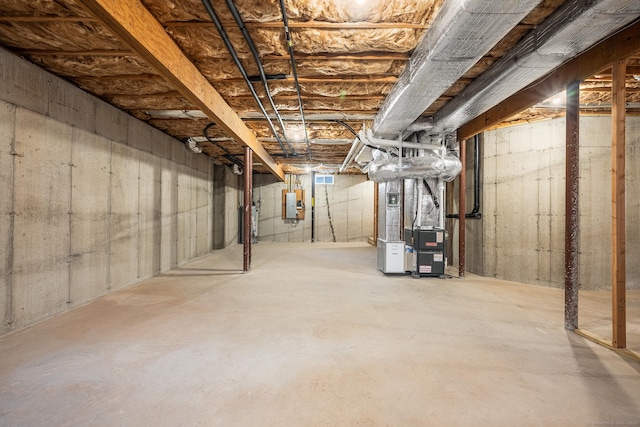 unfinished basement with electric panel and heating unit