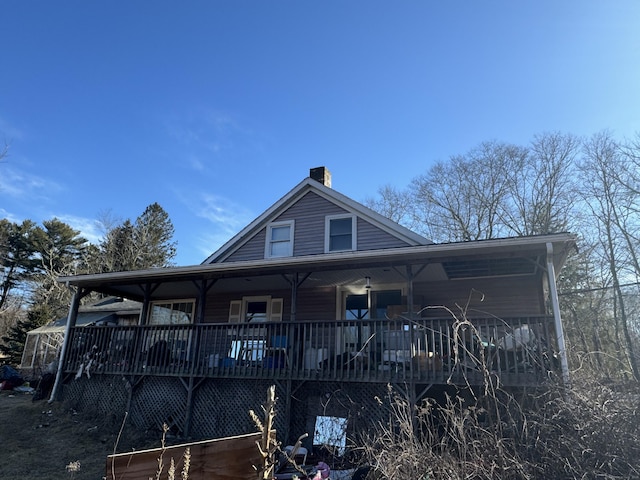 view of front of property featuring covered porch and a chimney