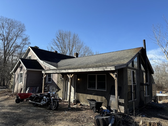 view of front facade with roof with shingles