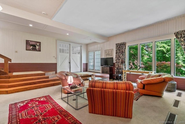 living room featuring recessed lighting, beamed ceiling, a healthy amount of sunlight, and carpet flooring