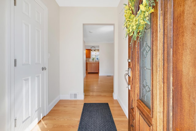 entrance foyer with visible vents, baseboards, and light wood-style floors