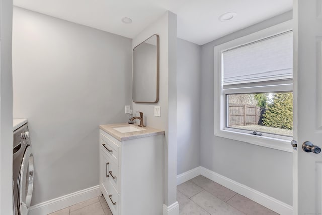 bathroom with tile patterned floors, vanity, and baseboards