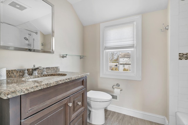 bathroom featuring visible vents, baseboards, toilet, lofted ceiling, and wood finished floors