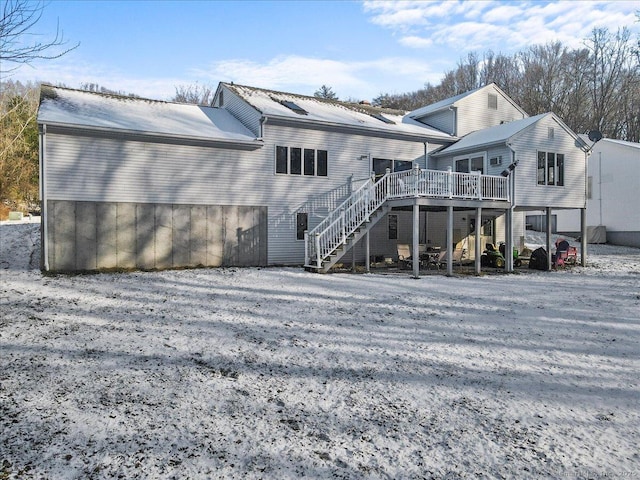 back of property featuring stairs and a wooden deck