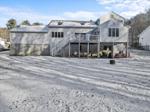 rear view of house featuring stairs and a deck