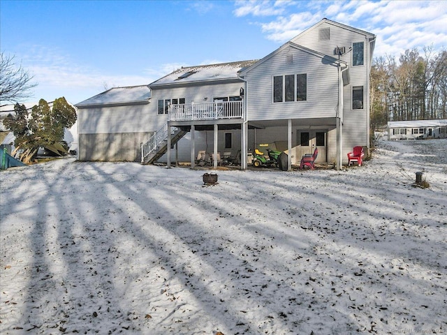 rear view of property with a deck and stairs