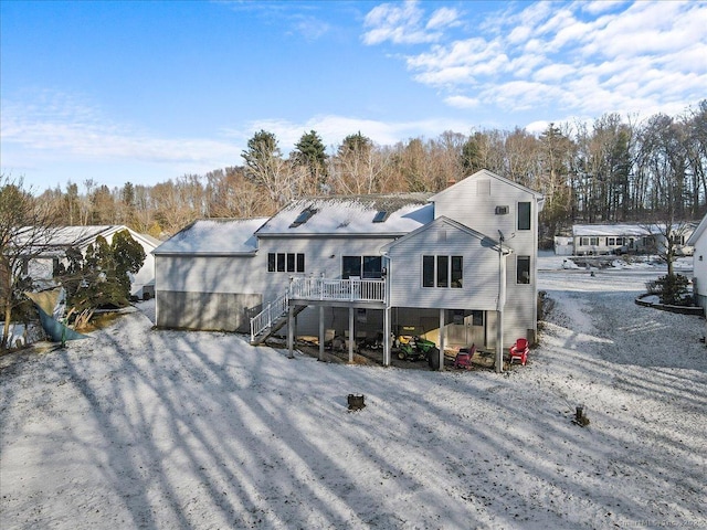 back of property featuring stairway and a deck