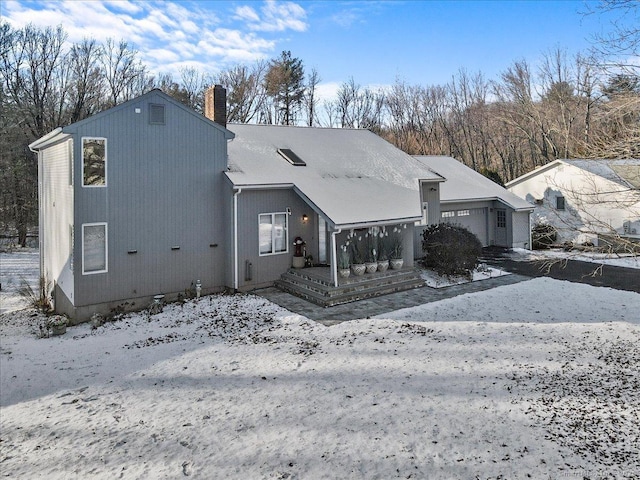 view of front of property with a garage and a chimney