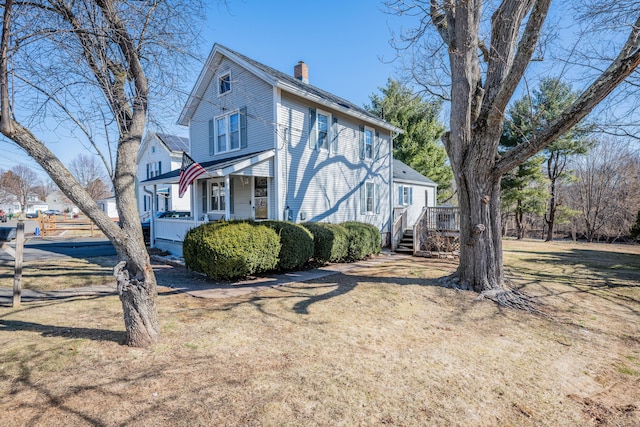 view of home's exterior featuring a porch and a chimney