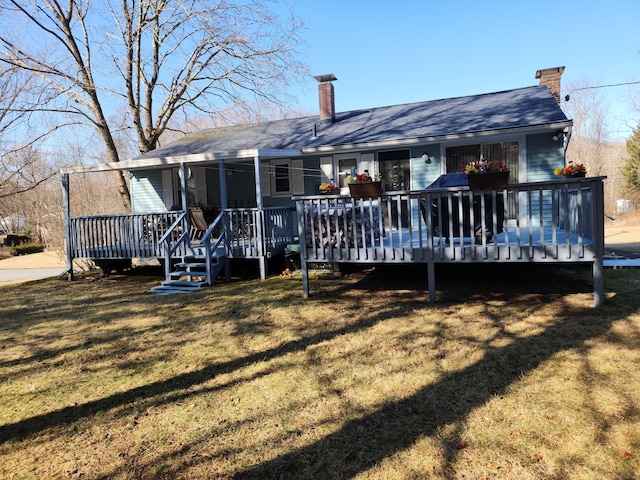 rear view of house featuring a yard and a chimney