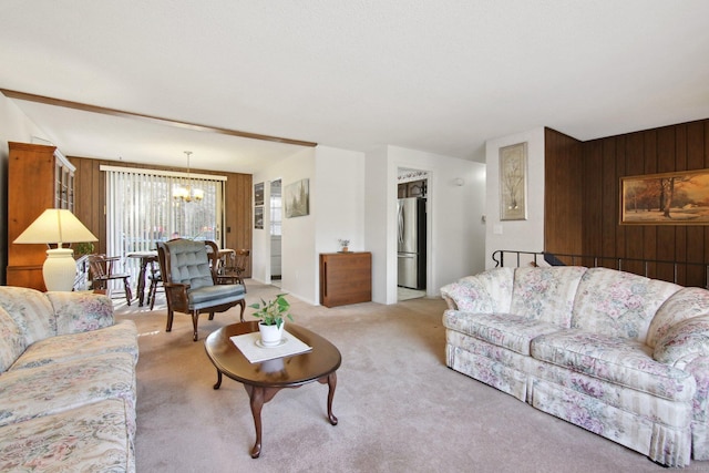 living area featuring an inviting chandelier, wooden walls, and light carpet