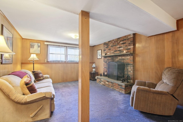 living area with wooden walls, a fireplace, and carpet