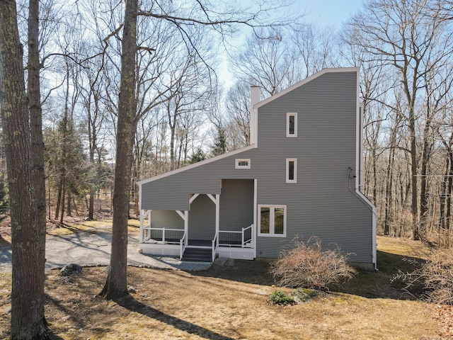 view of front of property with covered porch and a chimney