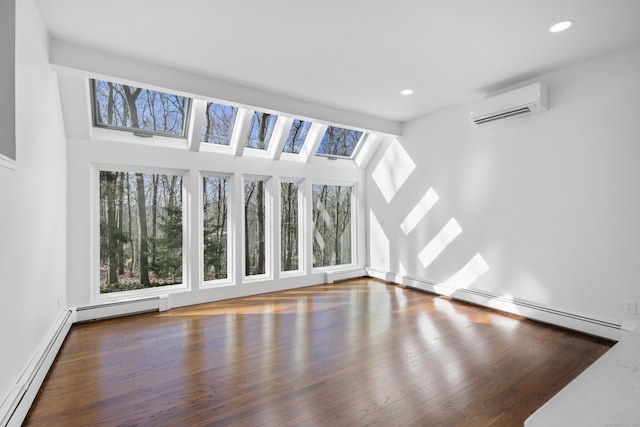 unfurnished living room featuring a baseboard heating unit, a wall unit AC, wood finished floors, and recessed lighting