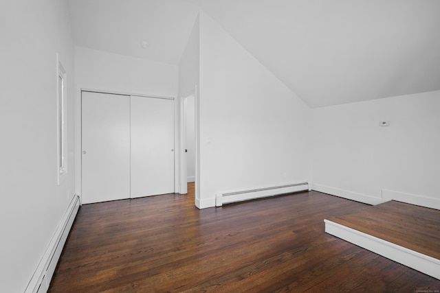 bonus room with a baseboard heating unit, lofted ceiling, and wood finished floors