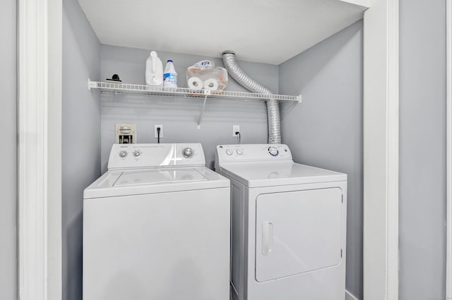 clothes washing area with washing machine and clothes dryer and laundry area