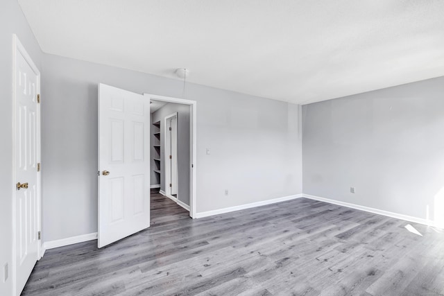 unfurnished bedroom featuring baseboards and wood finished floors