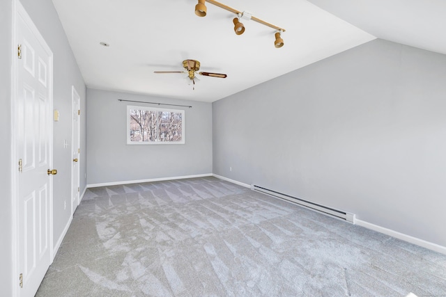 empty room with carpet flooring, baseboards, and a baseboard radiator