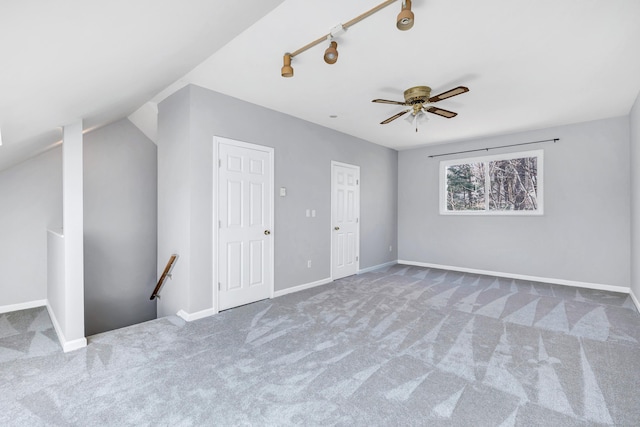 interior space featuring baseboards, carpet floors, and ceiling fan