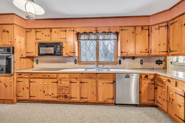 kitchen with a sink, light floors, black appliances, and light countertops