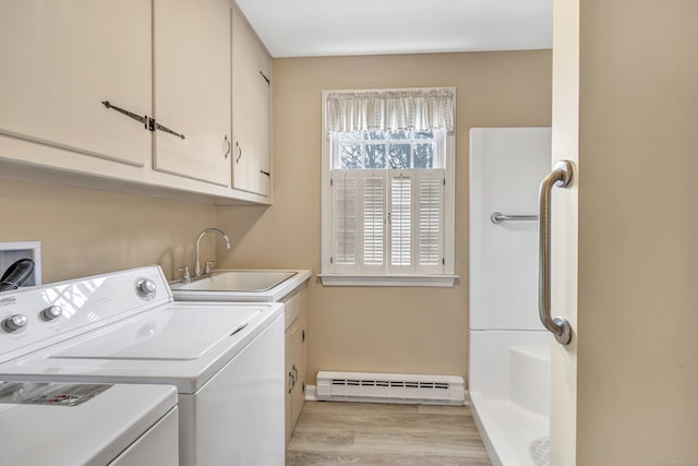 laundry room featuring independent washer and dryer, light wood-style flooring, a sink, cabinet space, and baseboard heating