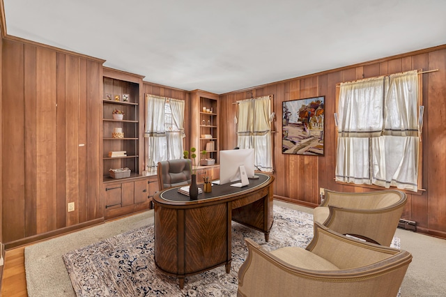 home office with wooden walls, baseboard heating, and baseboards