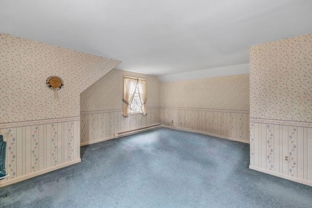 additional living space featuring a baseboard heating unit, carpet, wallpapered walls, baseboards, and vaulted ceiling