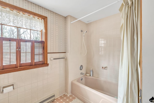 bathroom featuring wallpapered walls, tile walls, shower / bathtub combination with curtain, and a baseboard heating unit