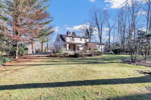 exterior space featuring a chimney and a front lawn