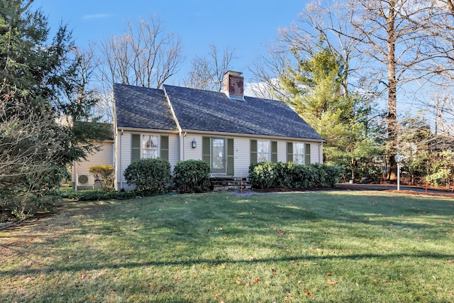 view of front of house featuring a chimney, a front yard, and roof with shingles