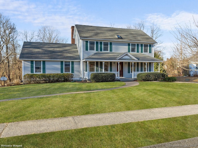 view of front of home with a porch, a front lawn, and a chimney