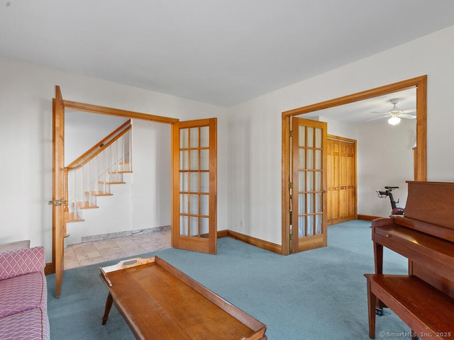 living area featuring french doors, carpet floors, baseboards, and stairway