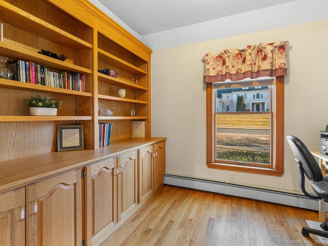 office space featuring light wood-style floors and a baseboard radiator