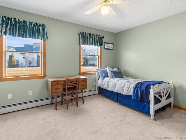 carpeted bedroom featuring ceiling fan, a textured ceiling, baseboards, and a baseboard radiator