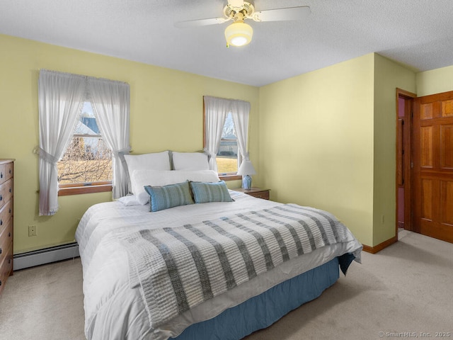 carpeted bedroom featuring baseboards, baseboard heating, a ceiling fan, and a textured ceiling