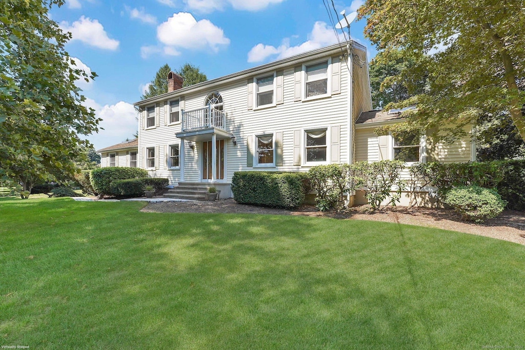 10 Cornfield Rd, Trumbull, CT 06611 - colonial-style house with a front lawn, a balcony, and a chimney
