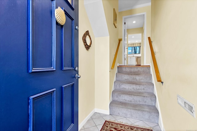 interior space featuring light tile patterned floors, visible vents, stairs, and baseboards