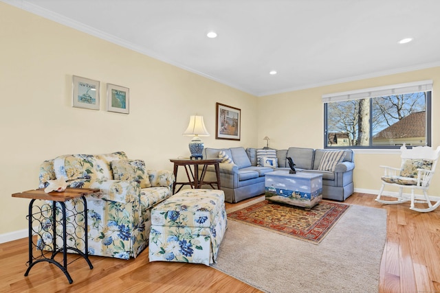 living area featuring crown molding and wood finished floors