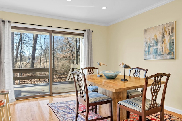 dining area with recessed lighting, wood finished floors, baseboards, and ornamental molding