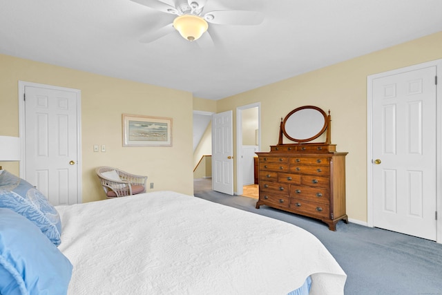 bedroom with carpet, ensuite bath, and a ceiling fan