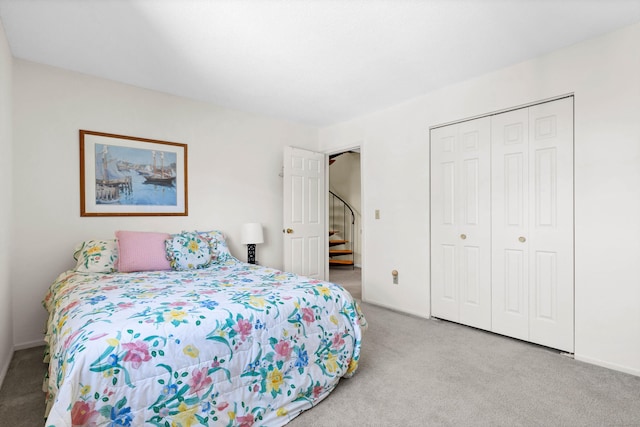 carpeted bedroom with baseboards and a closet