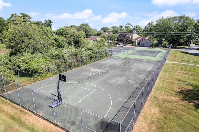 view of basketball court featuring a tennis court, community basketball court, and fence