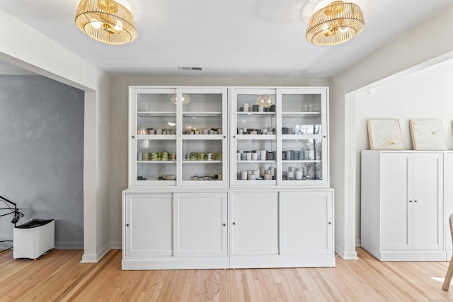 dining area with visible vents, baseboards, and light wood-style floors