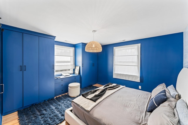 bedroom with visible vents and wood finished floors